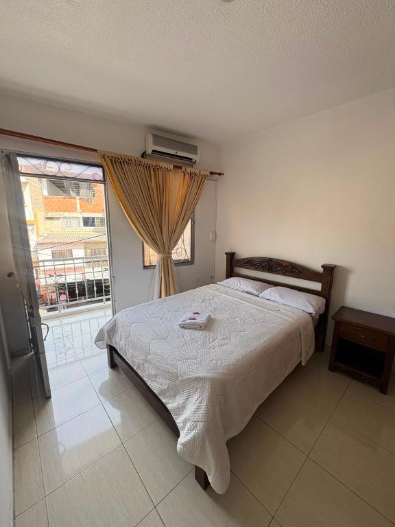 a bedroom with a large bed and a window at ConfortTrust Hotel in Ocaña