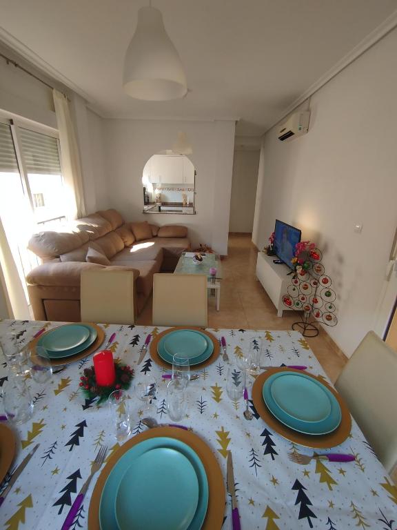 a living room with a table with plates on it at Le paradis de Lynn in Formentera de Segura
