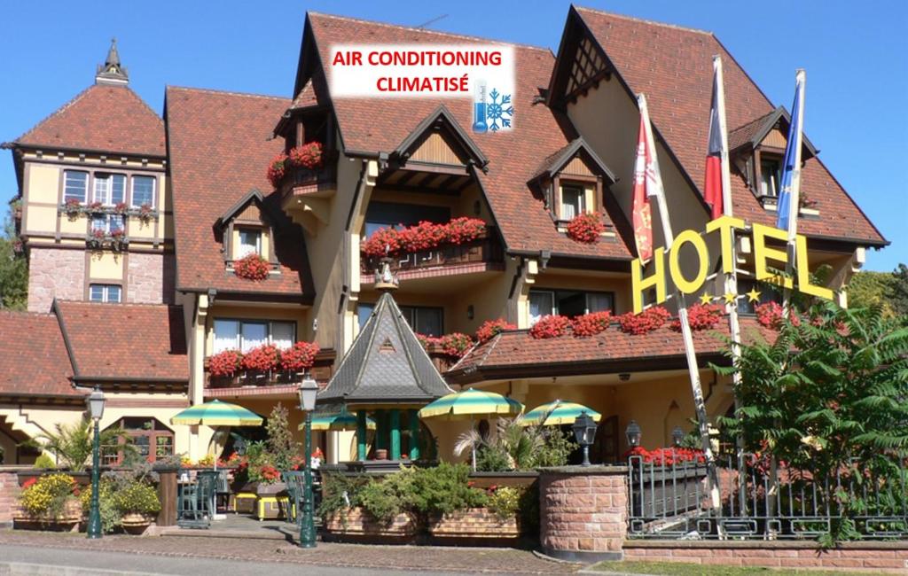 a hotel with a sign on the front of it at Hotel Le Mandelberg in Mittelwihr
