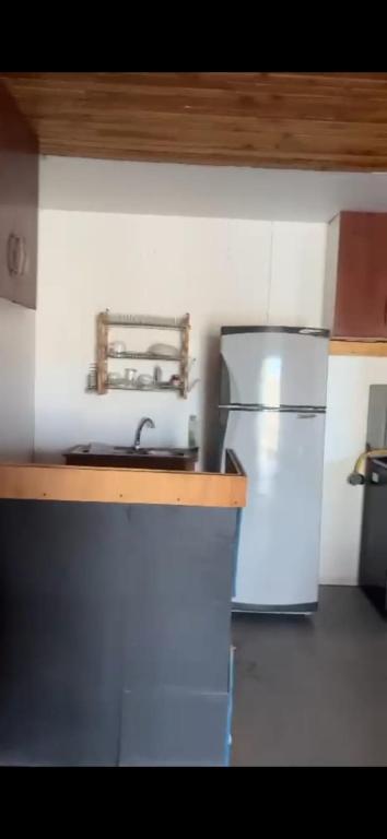 a kitchen with a sink and a refrigerator at Casa La Tirana Parcela 43 in La Tirana