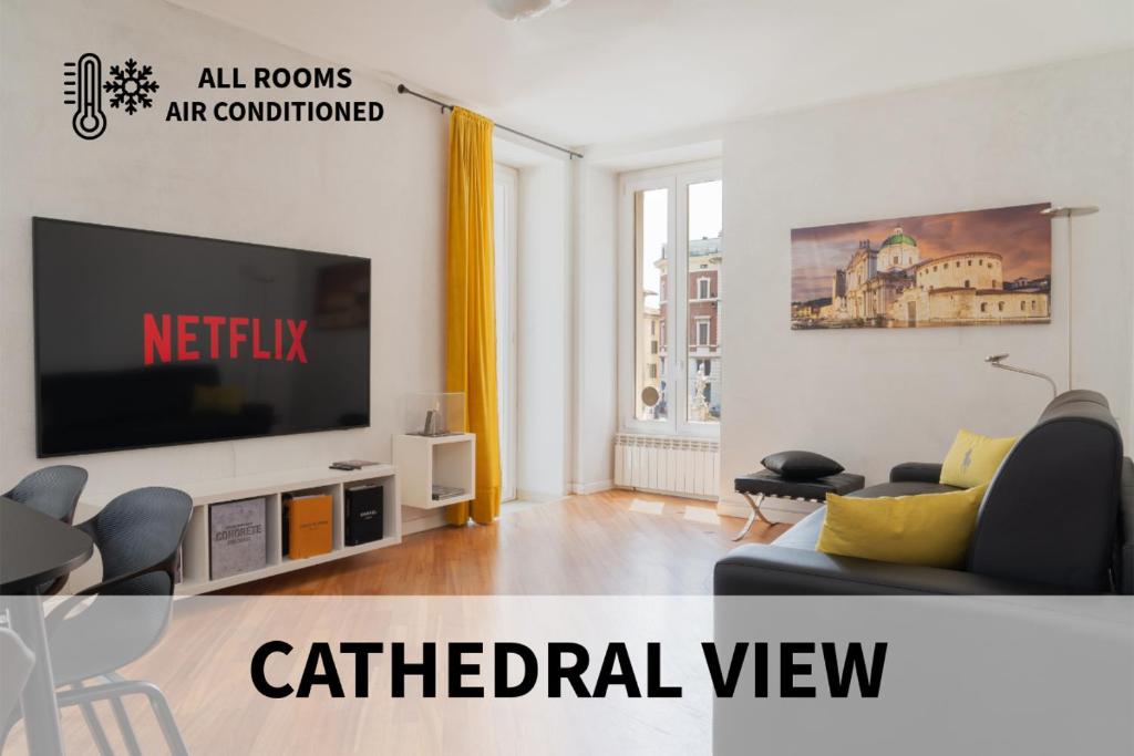 a living room with a tv and a couch at Piazza Duomo Cathedral View in Brescia