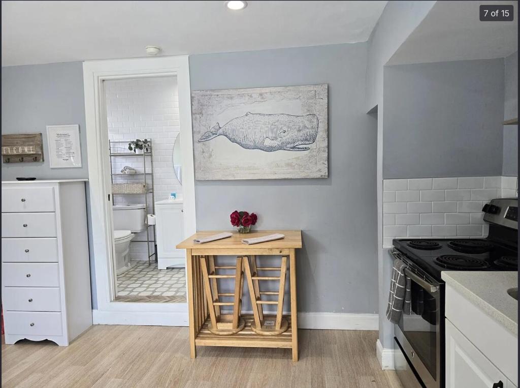 a kitchen with a table and a sink and a stove at Hideaway Steps off Atlantic Ave - Private Studio in Delray Beach