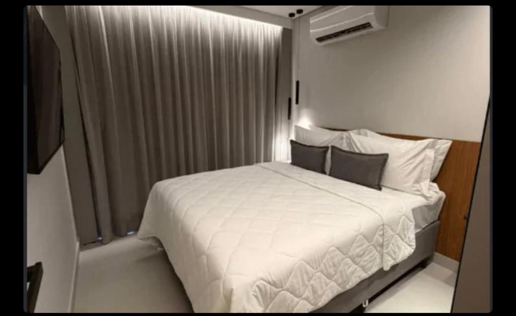 a bedroom with a white bed in a room at Beach resort Salinas in Salinópolis