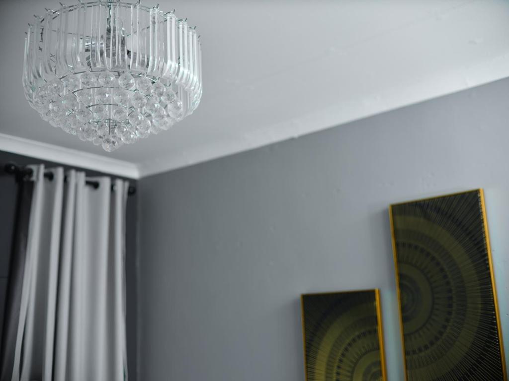 a chandelier hanging from a ceiling in a room at P Daisy in Rundu