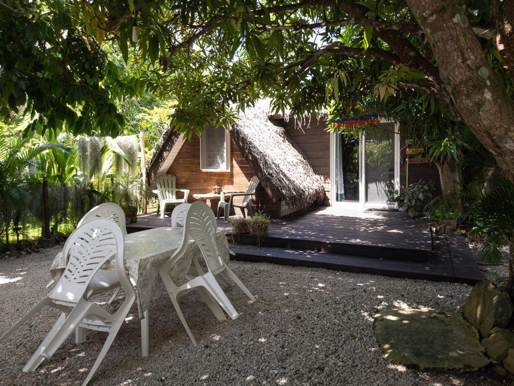 a group of chairs sitting in front of a house at Fare Vi in Puahua