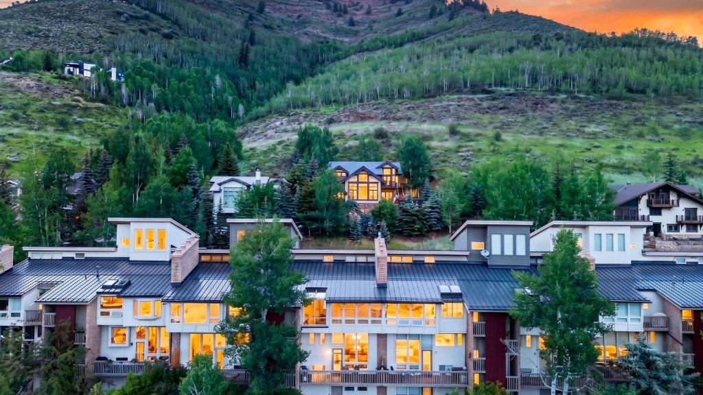a hotel with a mountain in the background at Serenity by the Slopes in Vail
