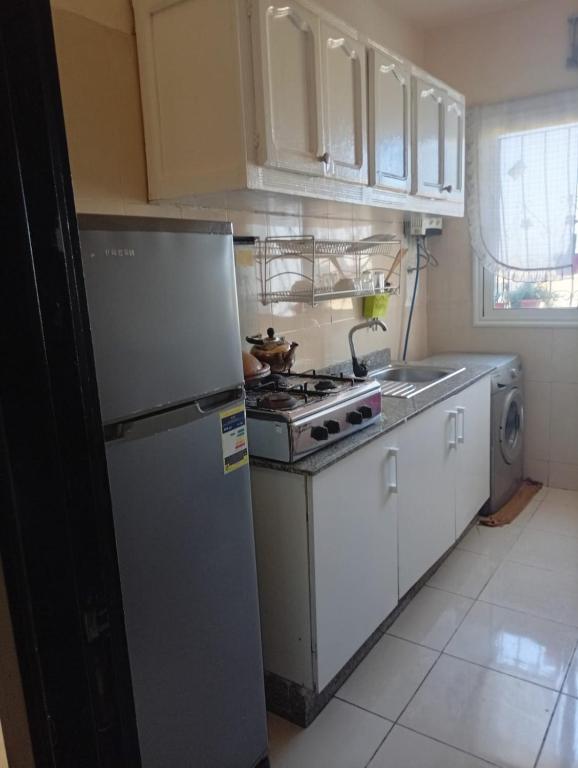 a kitchen with a refrigerator and a stove at الصخيرات in Skhirat