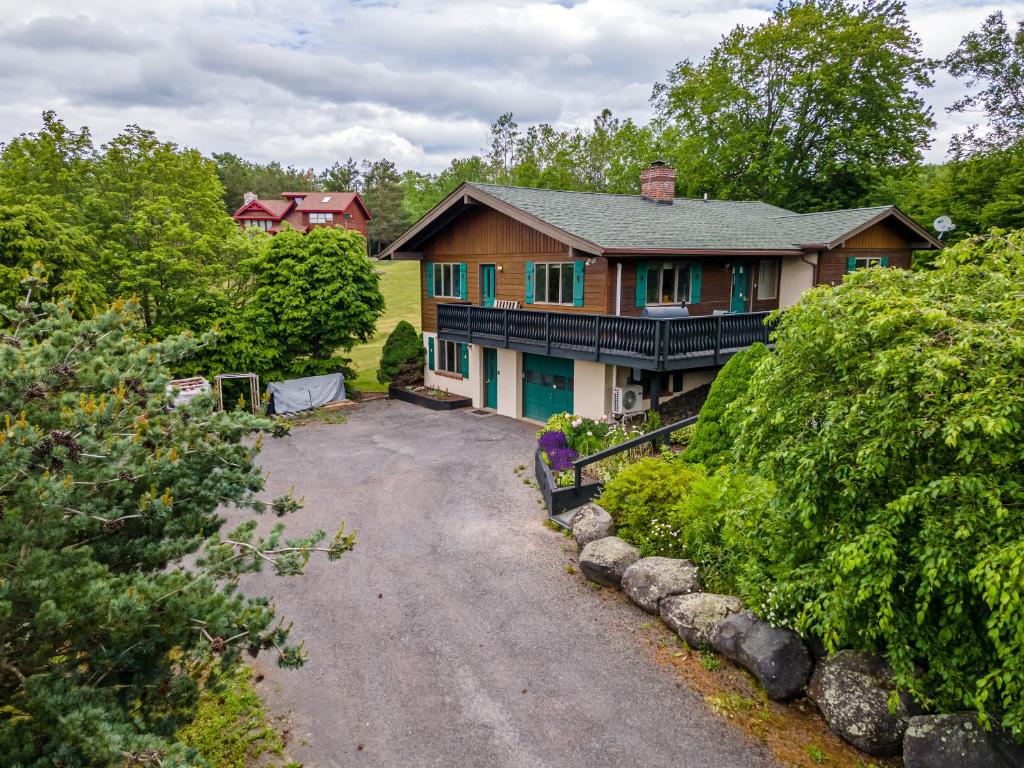 a large house with a driveway in front of it at Rustic Mountain view Cabin 5 mins to Ski Area! in Windham