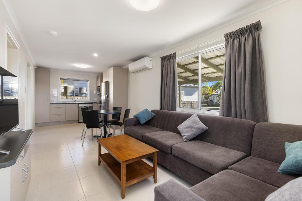 a living room with a couch and a table at Brisbane Gateway Resort in Rochedale