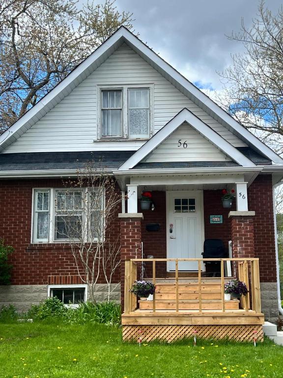 a house with a wooden porch in front of it at Private Cozy Room with Free Parking in Toronto