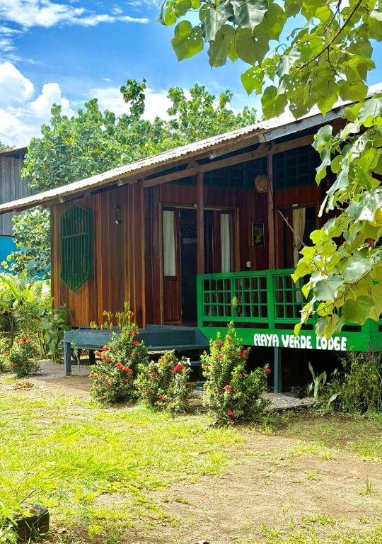 a small house with a bench in front of it at Playa Verde Lodge in Bahía Solano