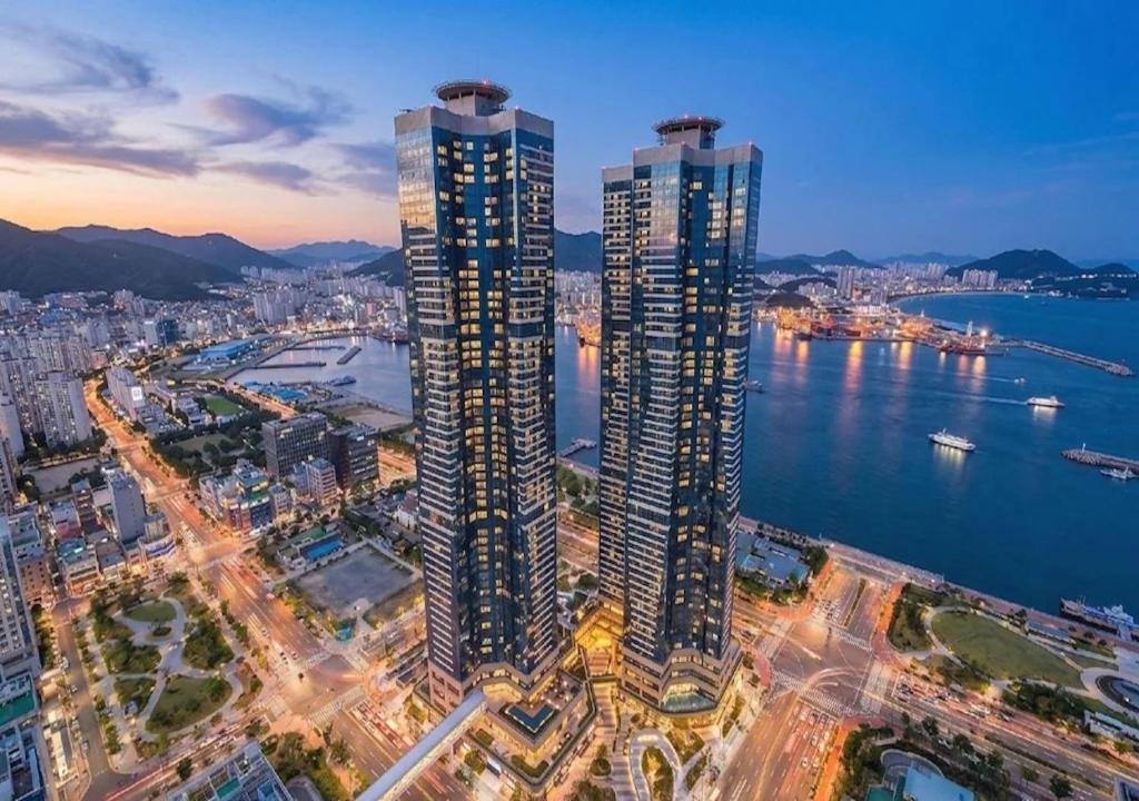 an overhead view of a city with tall buildings at Le Collective Busan station in Busan