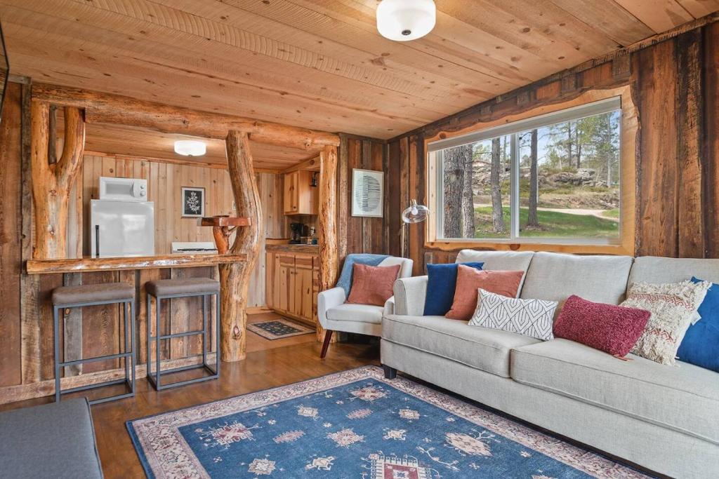 a living room with a couch and a kitchen at Little Joy BHBungalows #4 in Custer