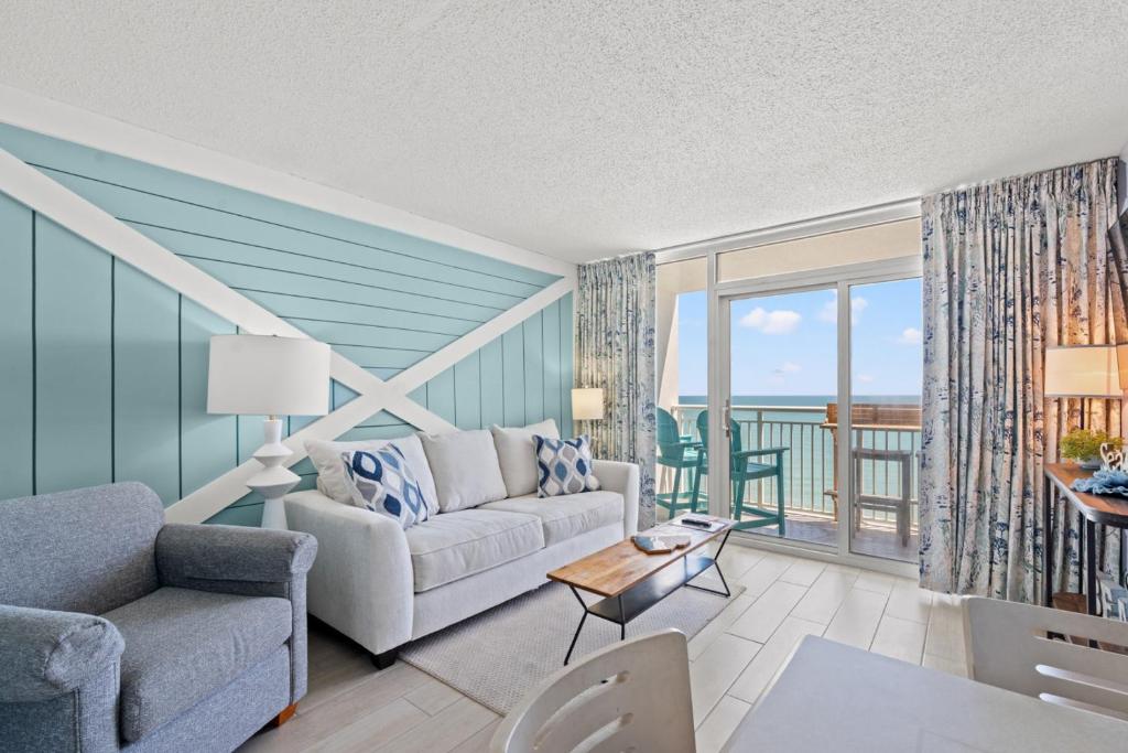 a living room with a couch and a table at Camelot by the Sea Resort Unit 1505 with Oceanfront Balcony in Myrtle Beach