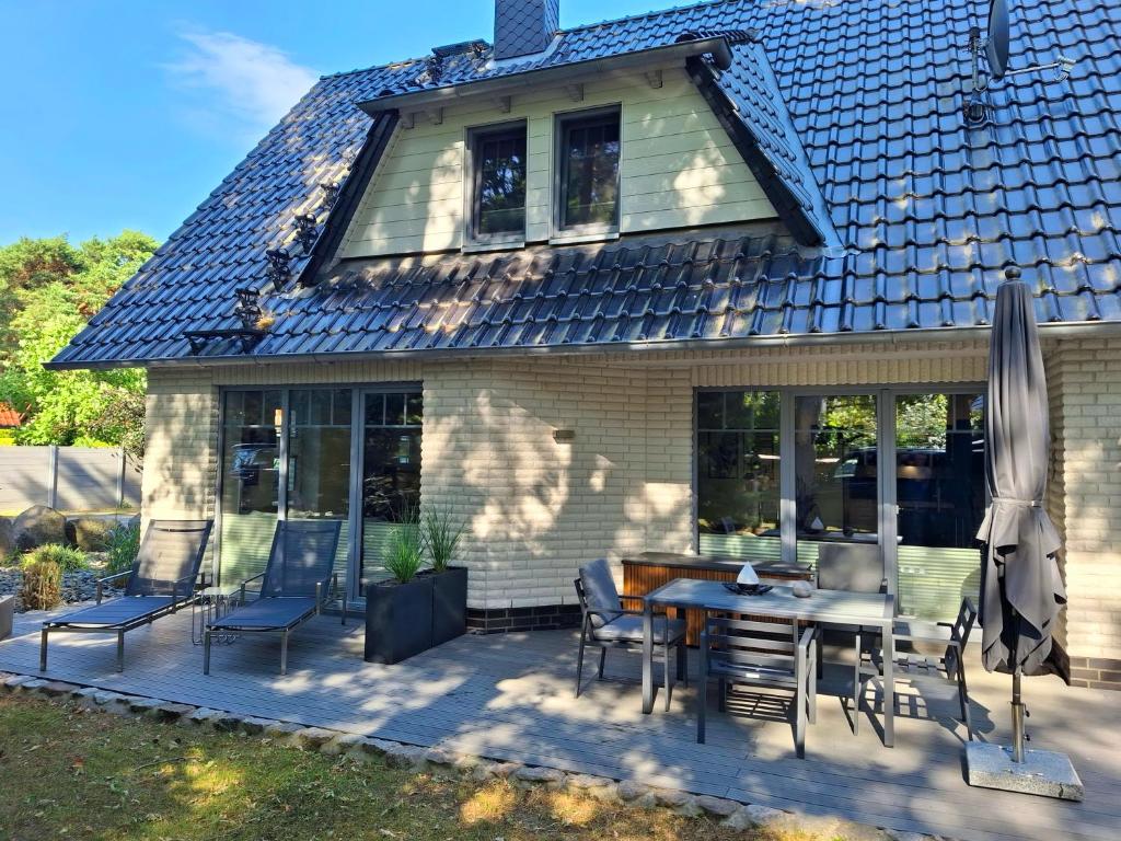 a patio with chairs and a table in front of a house at Ferienhaus Strandnah - Ostseeurlaub in Glowe in Top-Lage in Glowe
