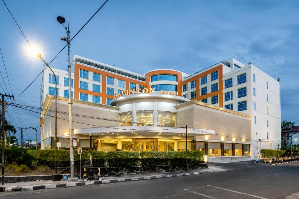 a large building with a building at Cavinton Hotel Malioboro Yogyakarta in Yogyakarta