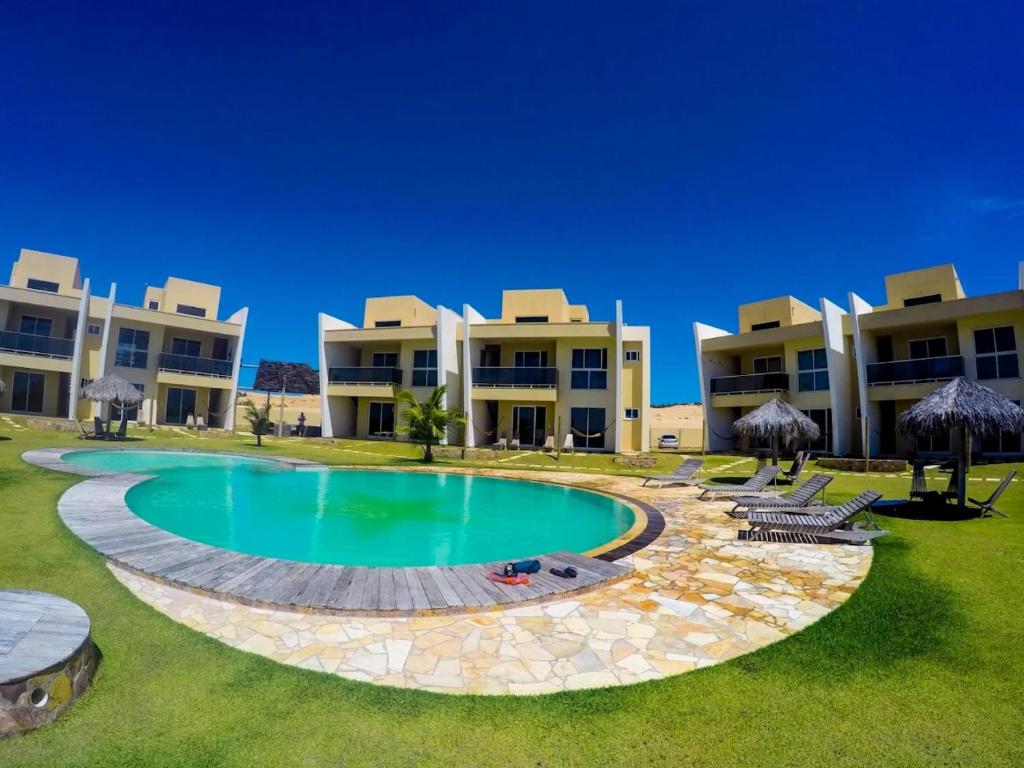 a large pool in front of some apartment buildings at Canoa Breeze - Beach Front in Canoa Quebrada