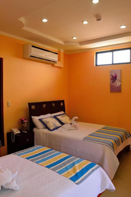 Postel nebo postele na pokoji v ubytování Hostal Duncan