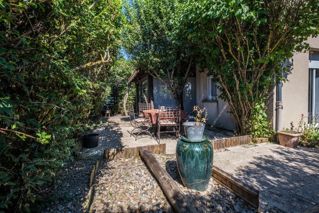 a green vase sitting in the middle of a yard at La villa d'alyxia in La Bastide-Puylaurent