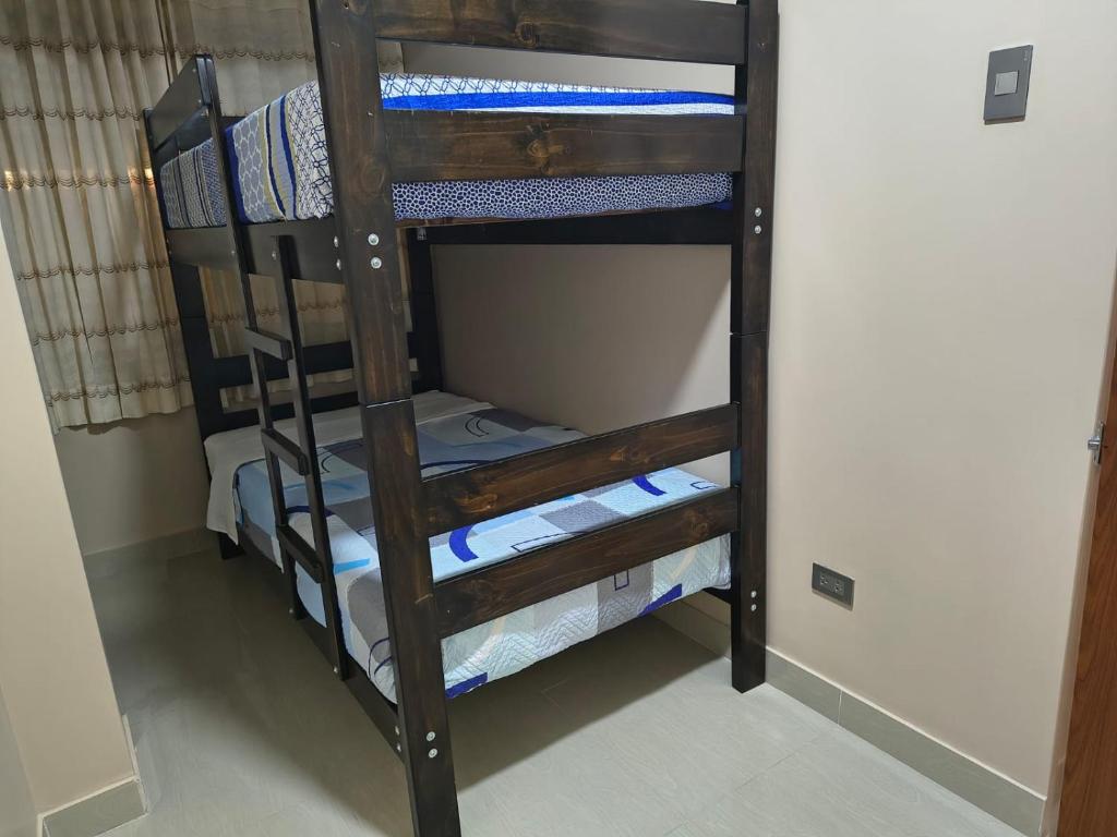 a bunk bed room with two bunk beds at Esencia de Altura Hostal in El Tambo
