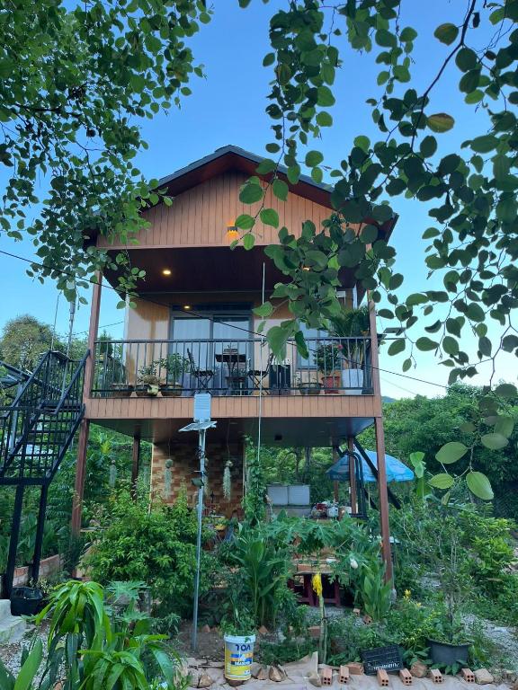 a tree house with a wrap around deck at Táo House in Vĩnh Hy