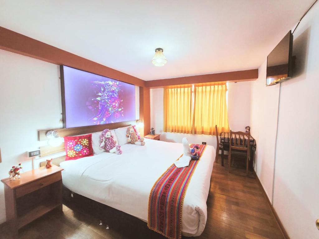 a hotel room with a bed with a large screen at Hotel Mirador All Sur in Cusco