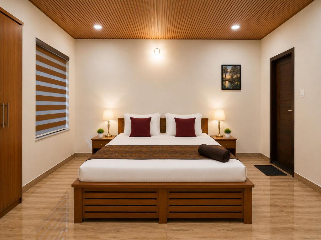 a bedroom with a large bed with red pillows at The Royal Pool Resort-Swimming Pool Resort, Varkala in Varkala