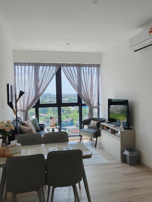 a living room with a table and a television at Milano8 Condominium Opposite Vivacity in Kuching