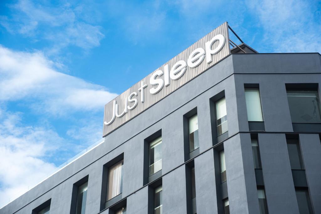 a building with a us steel company sign on it at Just Sleep Hualien ZhongZheng in Hualien City