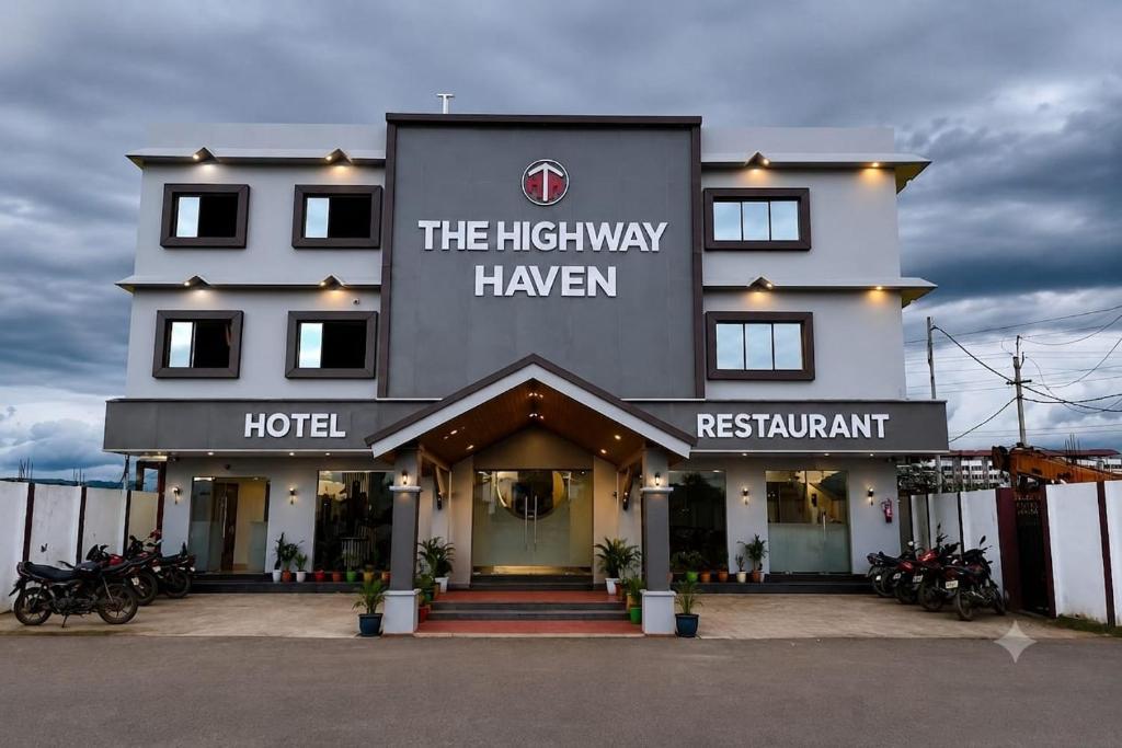 a hotel with motorcycles parked in front of it at The Highway Haven in Silchar