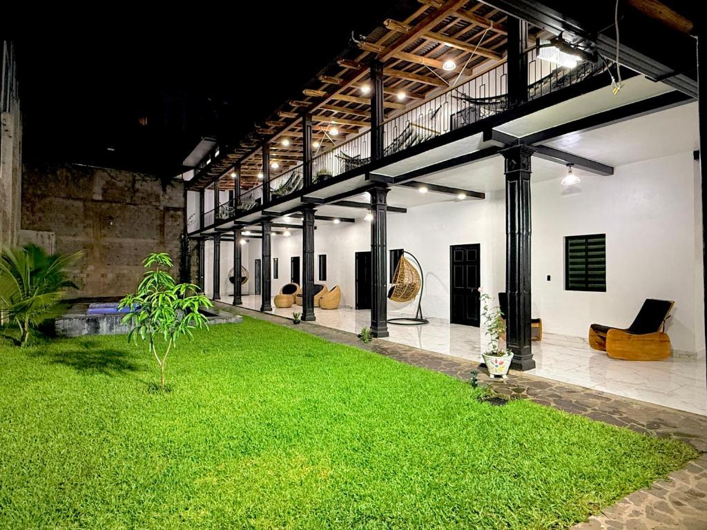 a large white building with a yard of green grass at La Casona Suchitoto in Suchitoto
