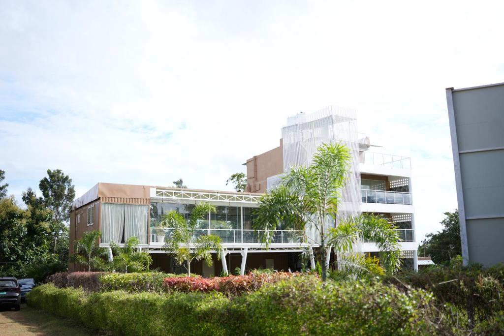 an apartment building with trees in front of it at Aadvik Luxury Farmstay in Antarasante