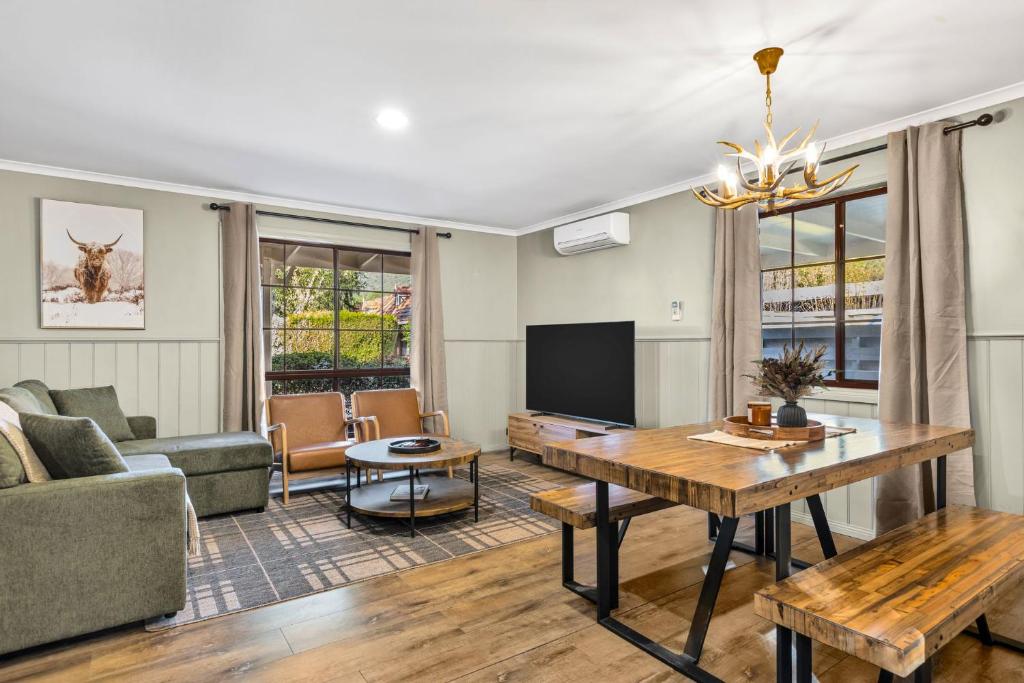 a living room with a couch and a table at Plum Pines Bright in Bright
