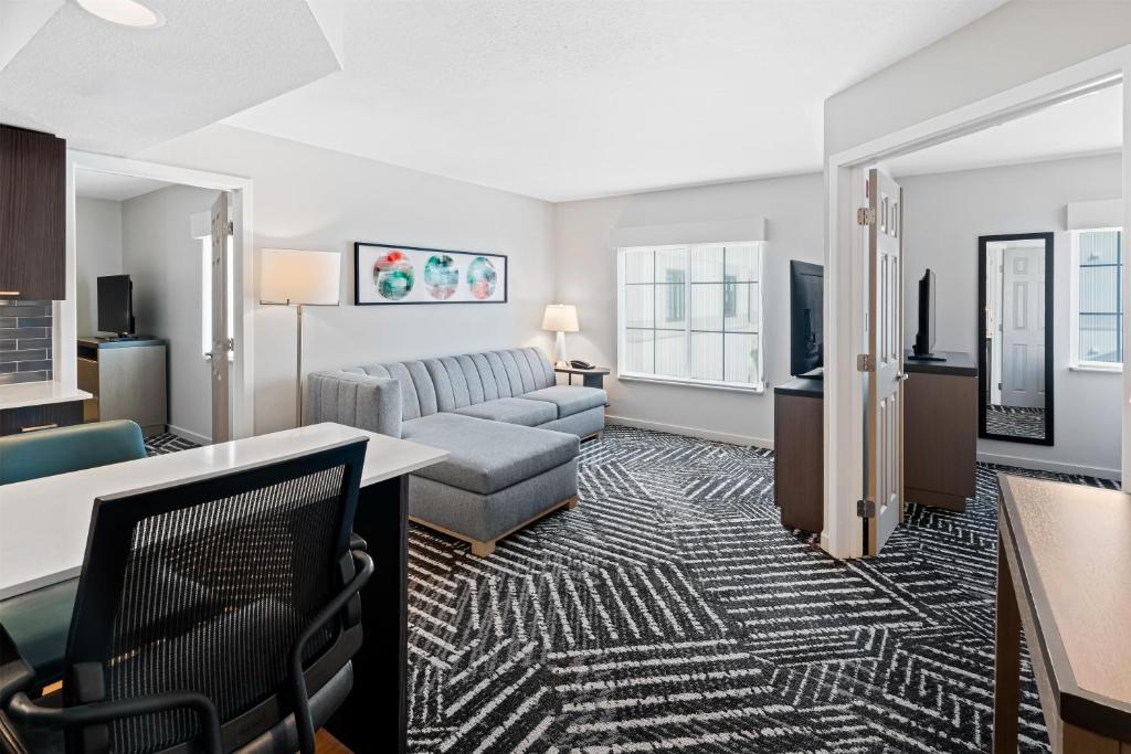a living room with a couch and a table at Hyatt House Boston/Burlington in Burlington