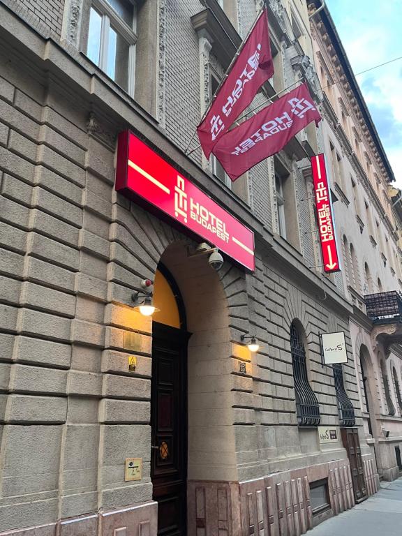 a building with signs on the side of it at TL Hotel Budapest in Budapest