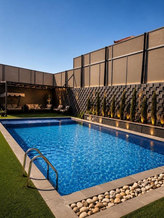 a swimming pool in front of a building at Ohio villa in Sowayma
