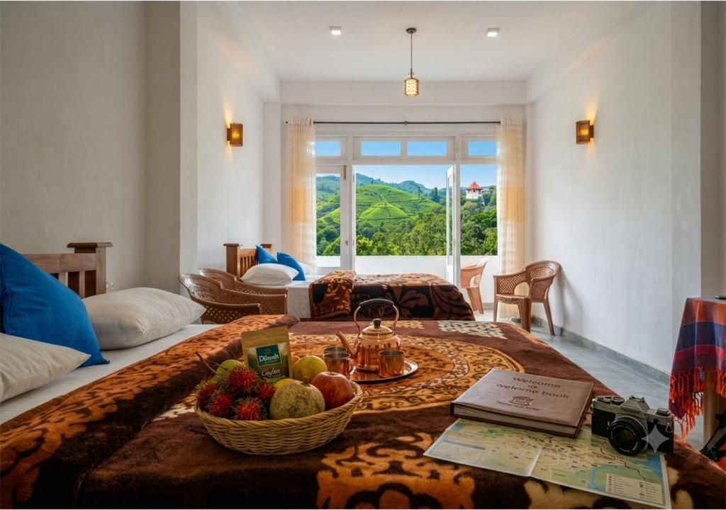 a living room with a table with fruit on it at Queens Ark in Nallathanniya