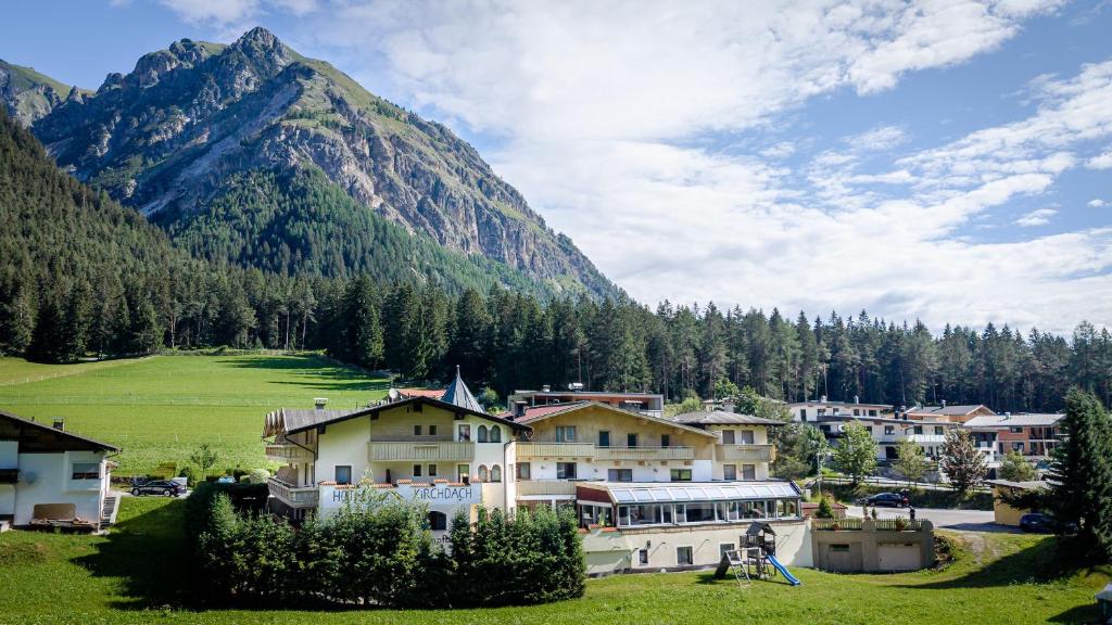 een dorp met huizen aan de voet van een berg bij Hotel Kirchdach in Gschnitz