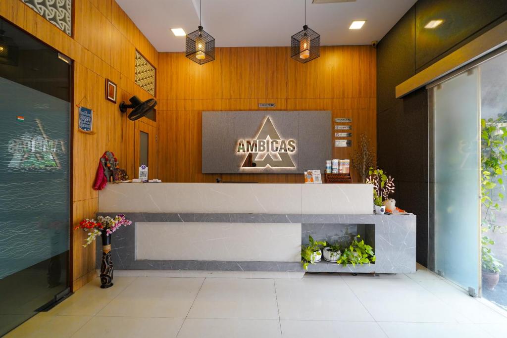 a restaurant with a counter and a sign on the wall at Open Hotel by Olive - Ambicas Grand in Visakhapatnam
