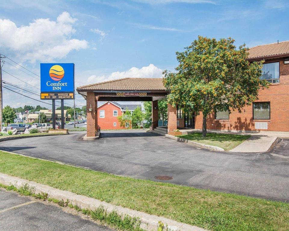 a gas station with a sign in front of it at Comfort Inn in Bathurst