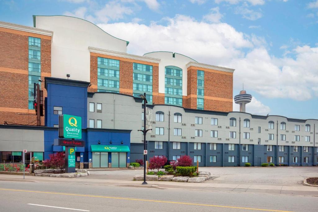 a building on a city street with a gas station at Quality Inn & Suites in Niagara Falls