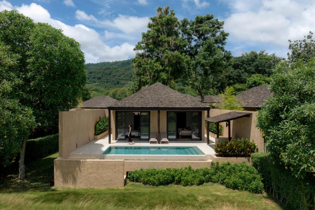 a house with a swimming pool in a yard at MUTHI MAYA Forest Pool Villa Resort - SHA Plus Certified in Mu Si