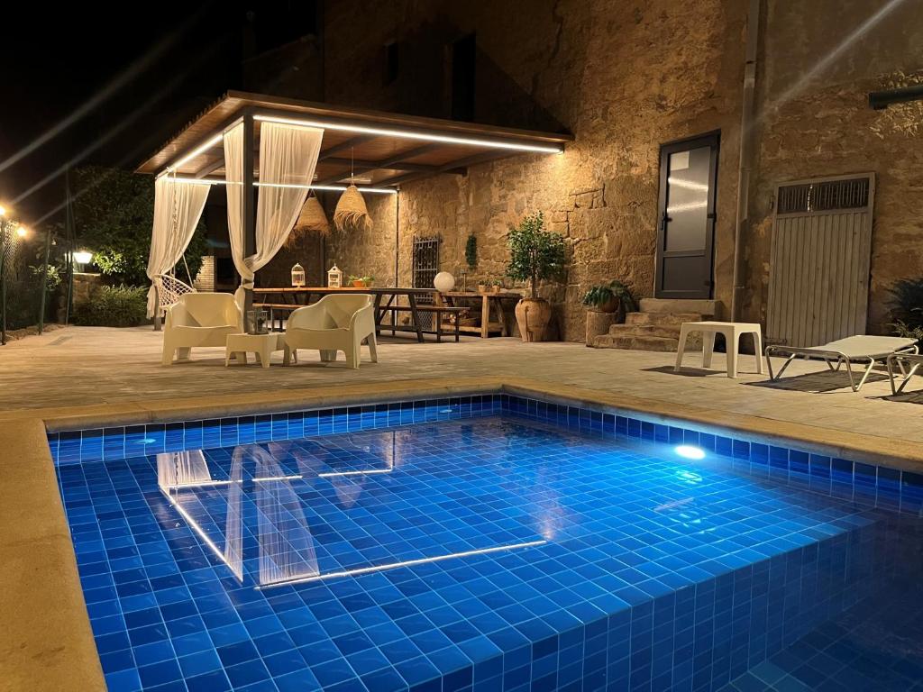 a swimming pool in a yard at night at Casa Rural Cal Xamora in Biosca