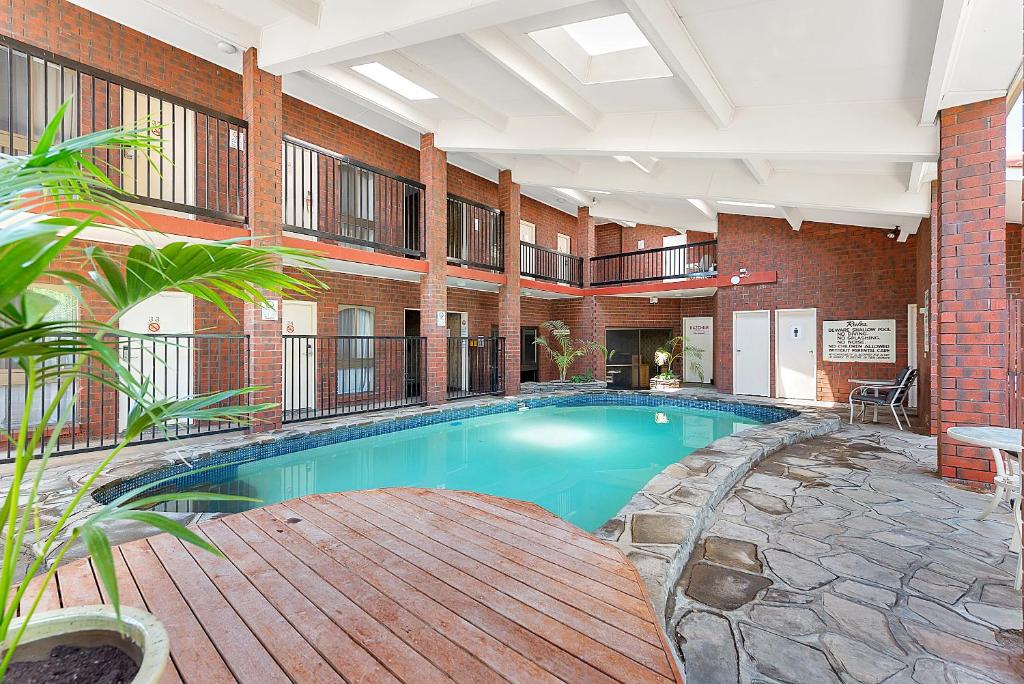 a large swimming pool in a large building at Comfort Inn & Suites Sombrero in Adelaide