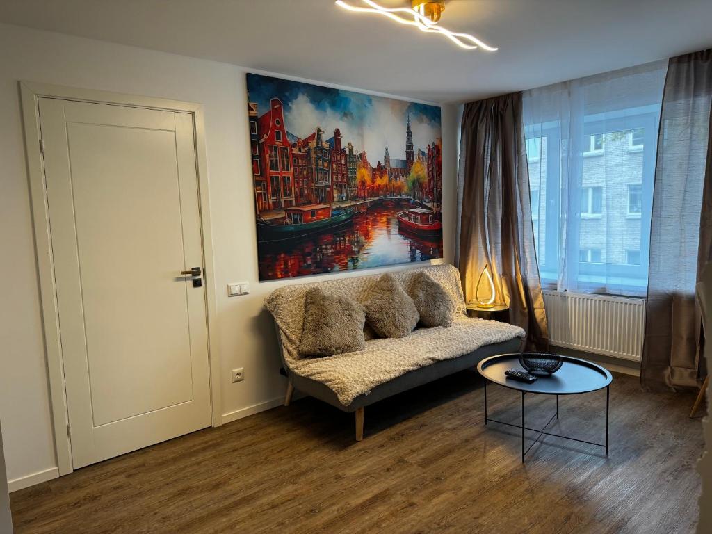 a living room with a couch and a painting on the wall at Amstel LUX in Narva