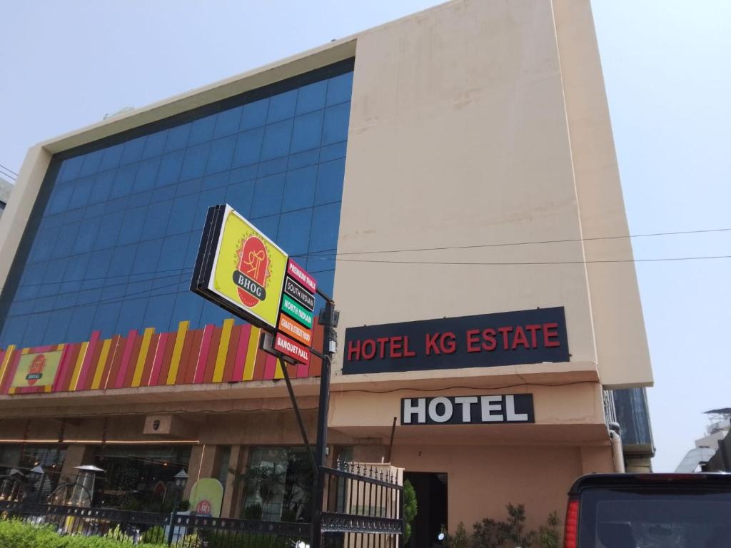 a hotel las office building with a sign in front of it at Hotel KG Estate in Jaipur