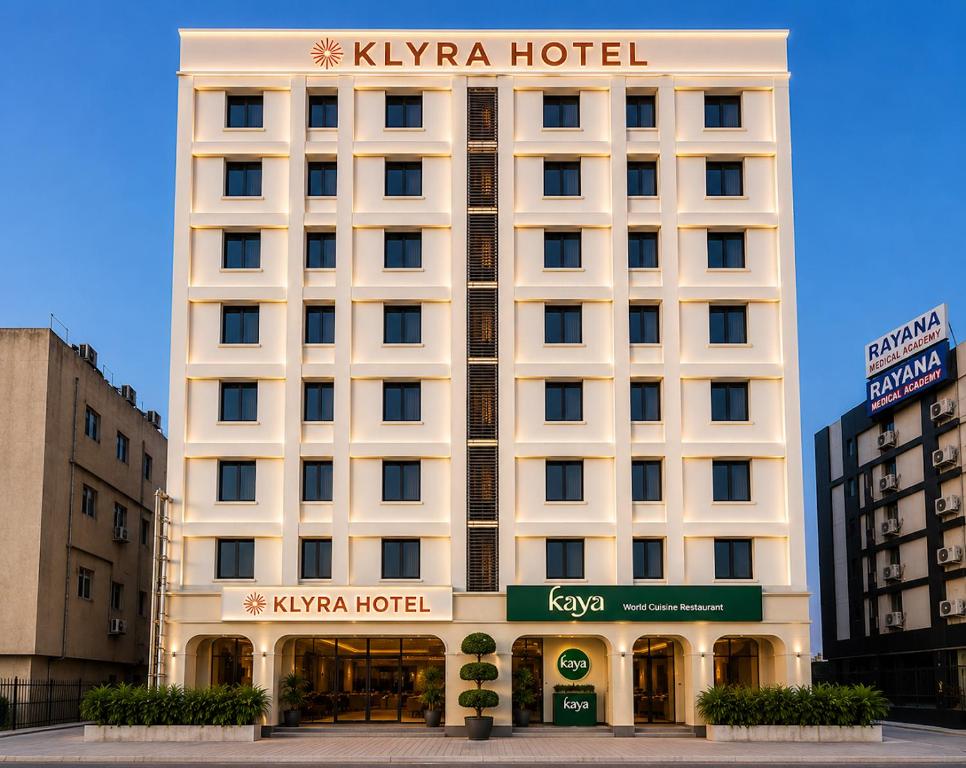 a large white building with a hotel sign on it at Klyra Hotel in Hyderabad