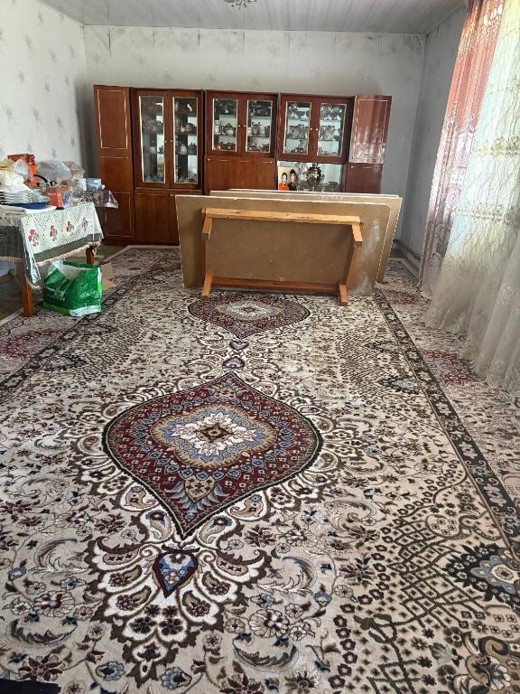 a living room with a large rug on the floor at Jumgal Nomad House in Kyzart