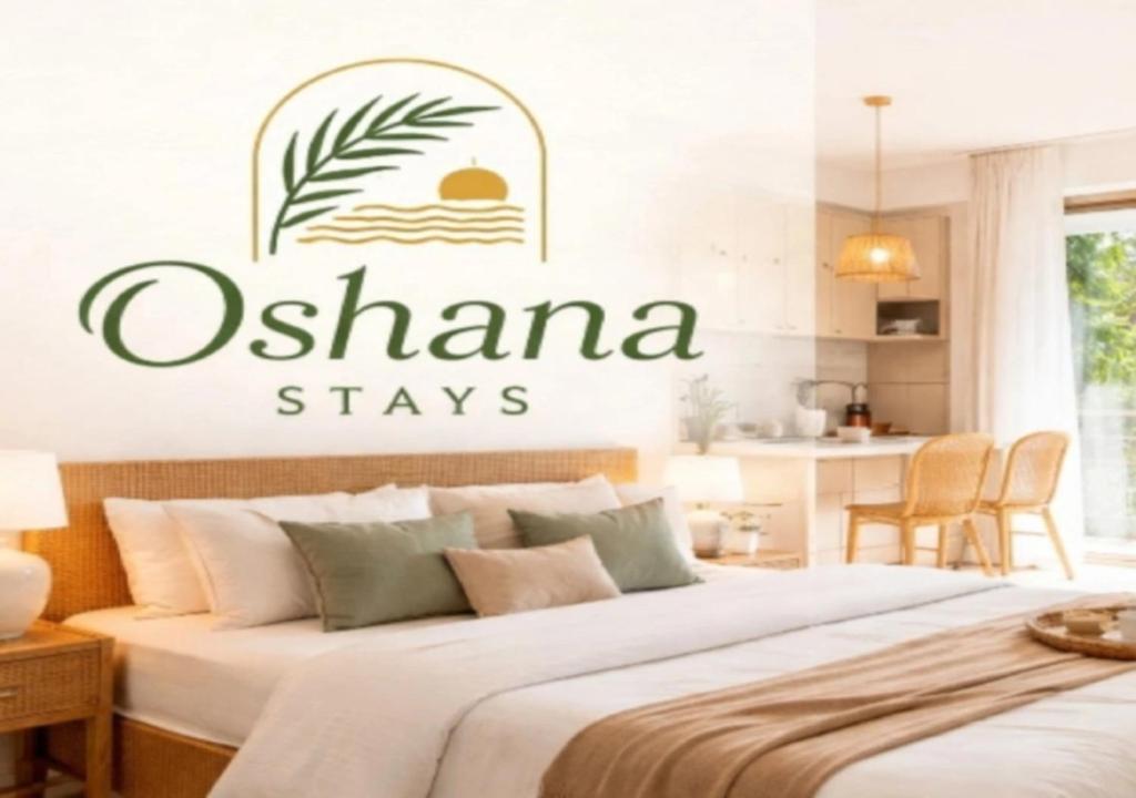 a bedroom with a bed with the words ochamana stays on it at Oshana Stays,Fully furnished Studio Apartment with Pool,Sauna,Siolim, Goa in Mapusa