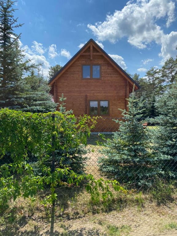 a wooden house with trees in front of it at Nela Martiany in Martiany
